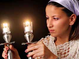 Jewish woman holding Kiddush candles
