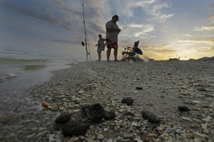 "Tar balls lie mixed with shells on the beach in Gulf Shores, Ala., in this June 11 file photo. Three years after the BP oil spill in the Gulf of Mexico, the petroleum giant and the Coast Guard say extraordinary cleanup operations in Alabama, Florida, and Mississippi are done. Louisiana officials want the effort to continue." Dave Martin/AP/File