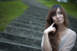 chinese-girl-sitting-on-steps-making-a-silly-face-pv
