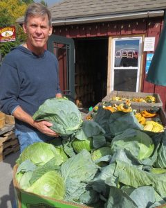 My husband, selecting a cabbage grown in upstate NY