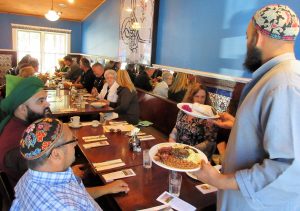 Hasan Sidiqi serves lunch at Tulip and Rose Cafe in Franklin, NY