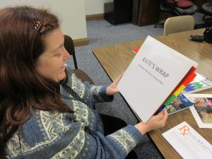 Kate Hewlett holds her WRAP binder