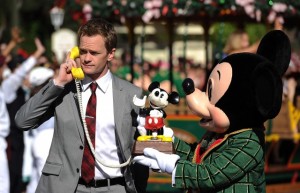 Neil Patrick Harris accepts a very important phone call from Mickey's own phone.