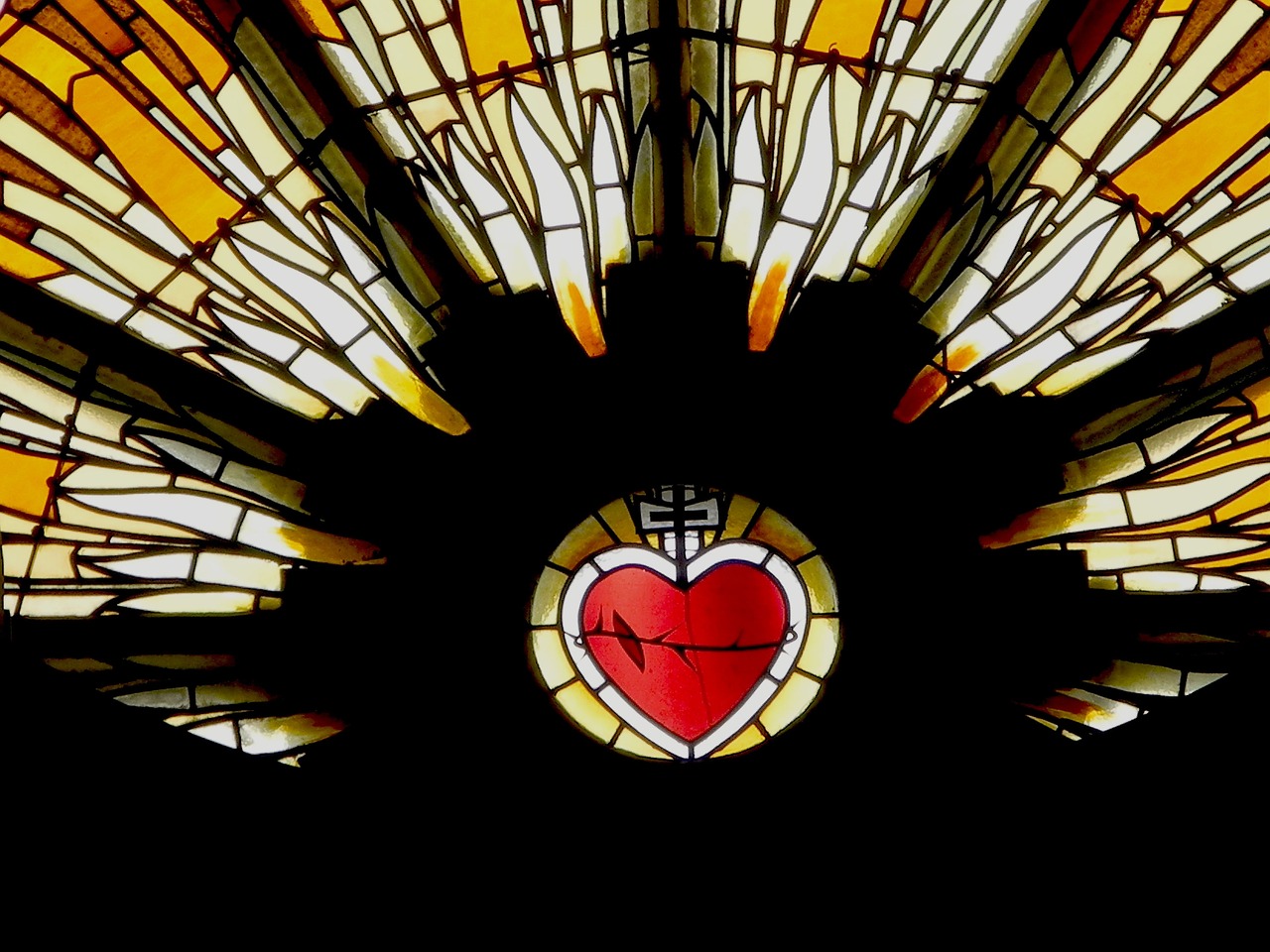 Church stained glass window with red heart 