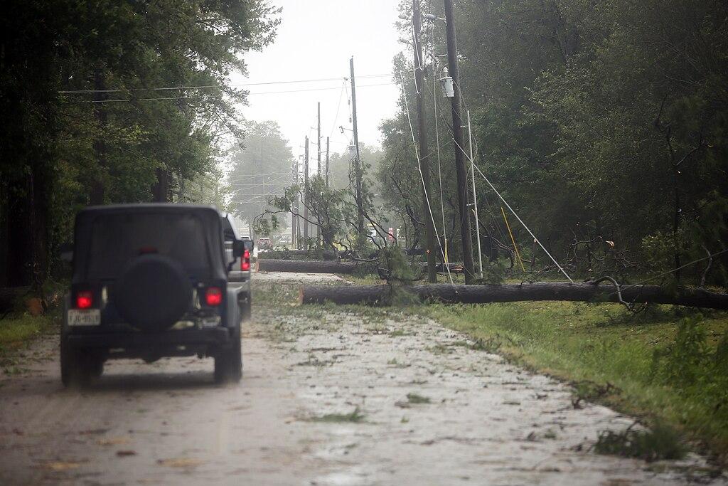 A jeep approaching downed power lines amid a hurricane