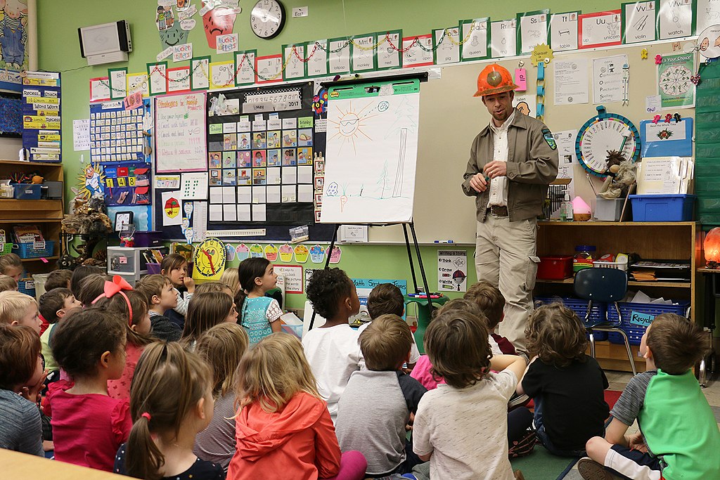 A forester speaks to second graders at Buckman Elementary