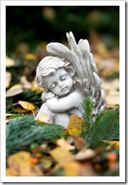 Sleeping angel sitting on a grave