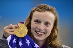 US swimmer Katie Ledecky poses on the podium after winning gold in the women's 800m freestyle final during the swimming event at the London 2012 Olympic Games on August 3, 2012 in London. AFP PHOTO / FABRICE COFFRINI (Photo credit should read FABRICE COFFRINI/AFP/GettyImages)
